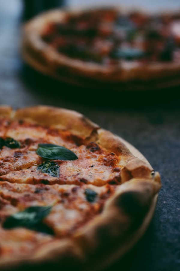 Napoletana-style pizza with basil leaves and charred crust