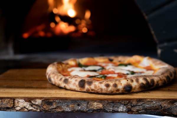 Brick oven pizza at Ganni's Pizzeria — wood-fired late-night kitchen